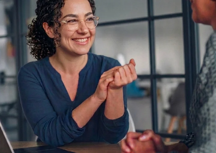 Anna Boshoer smiling during a client meeting